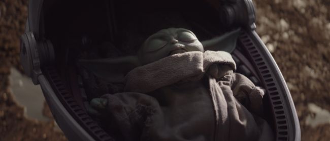 Image, baby Yoda sleeping in his carrier
