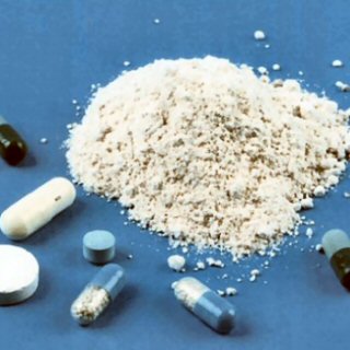 A pile of amphetamine powder, a couple of blue and white capsules, and a white pill